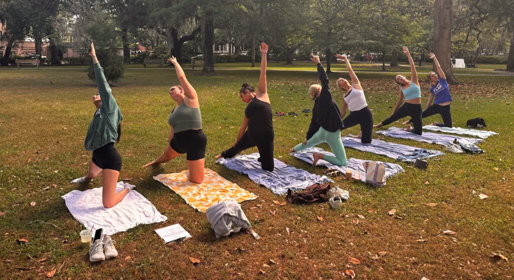 A bridal group practicing yoga in Forsyth Park.